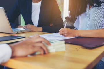 Business woman signing a loan for investment, negotiation