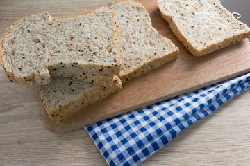 Top view of sliced wholegrain bread on a wooden table.