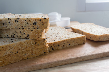 sliced wholegrain bread on a wooden table.
