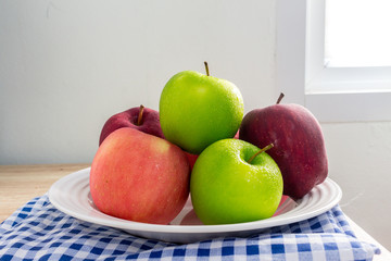 Ripe Green and Red apples on white table background.