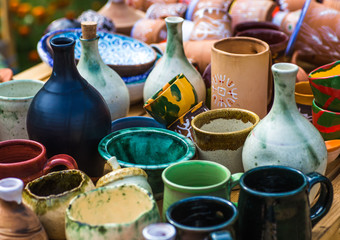 Ukrainian pottery. Pottery museum in Ukrainian village Oposhnya, center of Ukrainian pottery production. Different pottery products: bowls, pitchers, plates in museum.