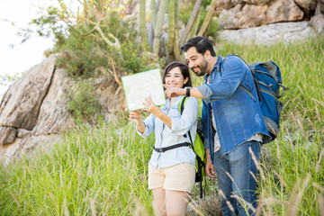 Couple checking a map while hiking