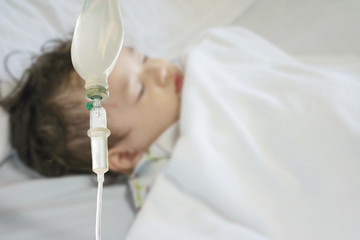 Closeup sick child sleep on hospital bed textured background with copy space