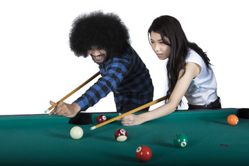 Fototapeta premium Two multiracial people playing billiards