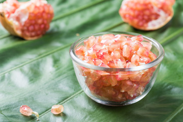 Pink juice pomegranate on leaf background