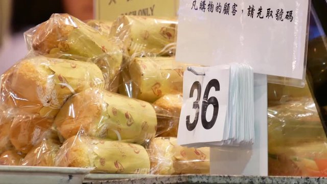 Motion of people taking number tag inside Chinese cake and bread store