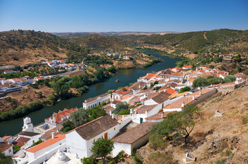 Fototapeta premium View of Guadiana river bend and residential houses of Mertola city on the ripe. Mertola. Portugal