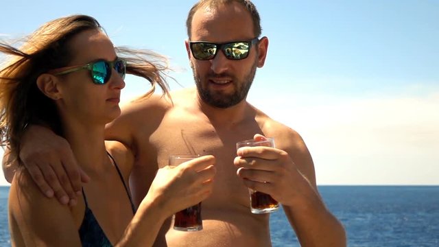Couple raising, toast with beverages sailing boat on sea, super slow motion 240fps
- Powered by Adobe