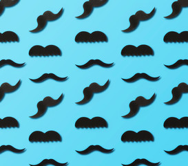 Father's Day concept. Paper mustache on blue background, top view