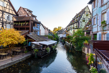Fototapeta na wymiar Beautiful view of the historic town of Colmar, also known as Little Venice, boat ride along traditional colorful houses on idyllic river Lauch in summer, Colmar, Alsace, France