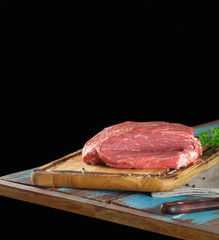 Fresh raw piece of beef tenderloin on wooden table