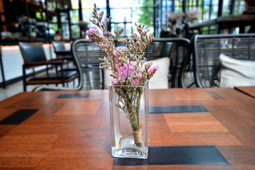 Dry flowers in glass vase on the table