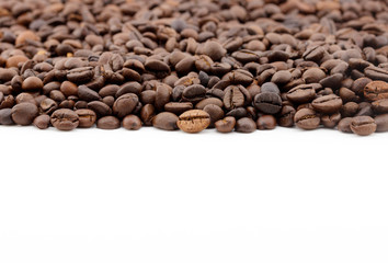 row of coffee beans isolated on white background