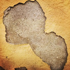 Damaged wall plaster on a stone wall
