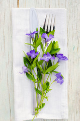 Festive Table setting with purple flowers.