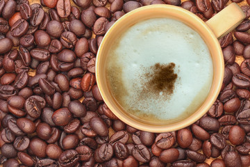 Hot coffee cup on coffee beans background.