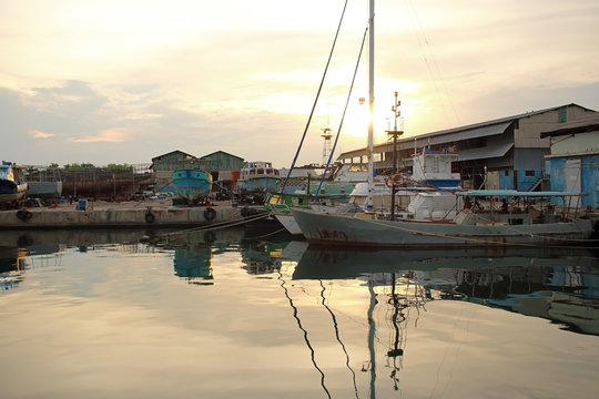 Old boats at the port of Cienfuegos at sunset