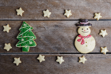 Festive Christmas Cookie and New Year in the shape of Christmas tree, snowman, Snowflake, star on wooden table
