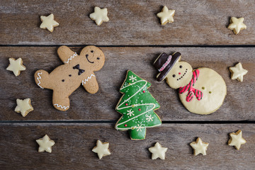 Festive Christmas Cookie and New Year in the shape of Christmas tree, Gingerbread man, snowman, Snowflake, star on wooden table