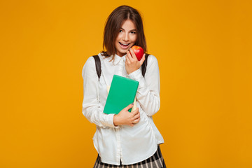 Portrait of a pretty schoolgirl holding books