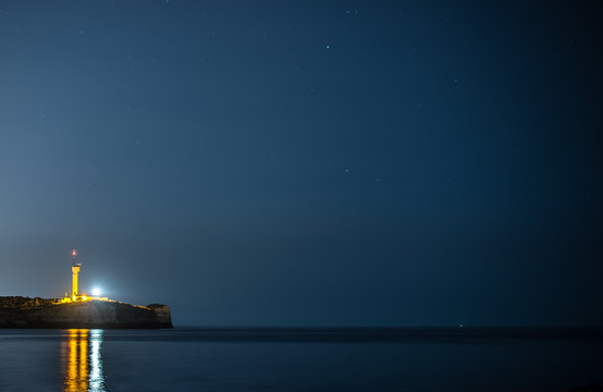 Lighthouse at night in Portimao, Portugal.