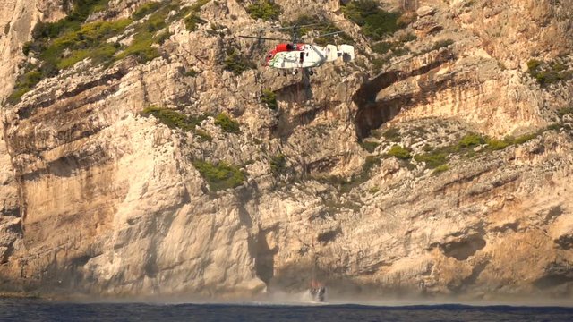 Firefighting helicopter flying over island, super slow motion 240fps
