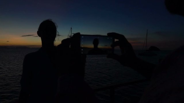 Man doing photos of his girlfriend at night, slow motion shot at 240fps, steadycam shot  

