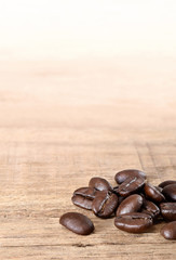 Coffee beans on wooden table.