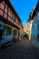 Beautiful village Riquewihr with historic buildings and colorful houses in Alsace of France - Famous vine route