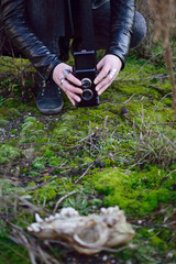 girl is holding retro camera