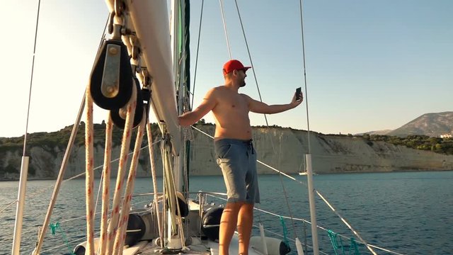 Man taking selfie photo while sailing boat on sea, super slow motion 240fps
