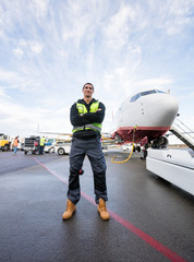 Confident Worker Standing Arms Crossed On Wet Runway