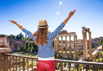 young tourist woman near Roman Forum in Rome, Italy rejoicing