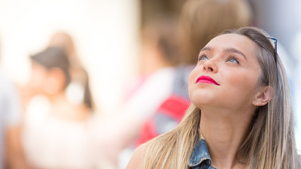 Fototapeta premium Beautiful teenager girl looking up, close up photo with defocused copy space background