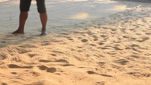 worker cleaning sand beach in morning