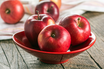 Fresh apples in ceramic vase