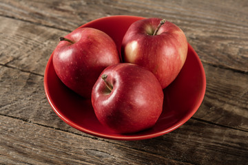 Fresh apples in ceramic vase