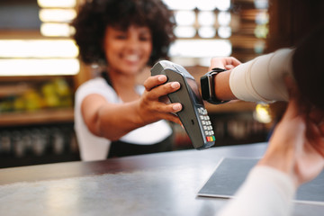 Customer paying bill using a smartwatch