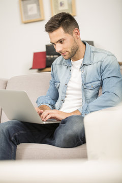 Upper view of young man using laptop computer at home