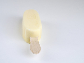 Ice cream covered with white chocolate on white background