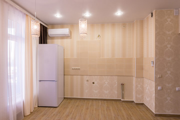 Interior of an empty kitchen without furniture, in studio apartment