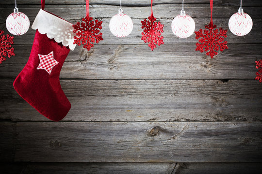 Christmas stocking hanging against wooden background