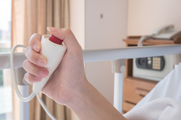 hand pushing nurse call button