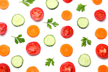 mix of sliced cucumber with sliced carrot and tomato isolated on a white background top view