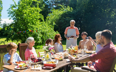 happy family having dinner or summer garden party