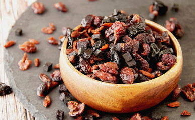 sliced dried fruits in a wooden bowl on the table