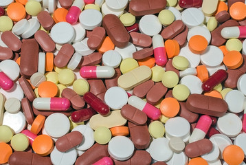 Fototapeta na wymiar Multicolored medical pills background