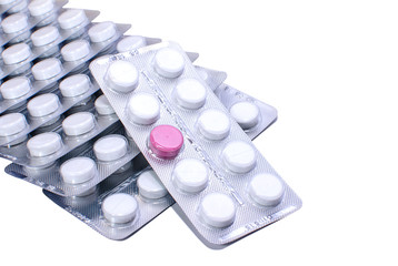 One red pill and many white ones in blister packs