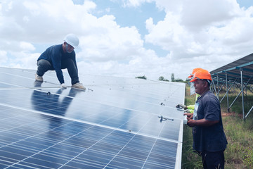 engineer team working on replacement solar panel in solar power plant;engineer and electrician team swapping and install solar panel ; electrician team checking hot spot on break panel
