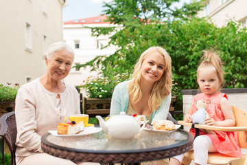 mother, grandmother and granddaughter at cafe